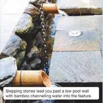 Stepping stones lead you past a low pool wall with bamboo channelling water into the feature. 